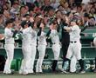 　５回、４０号２ランを放ちナインの出迎えに笑顔を見せる佐藤輝（右端）＝撮影・立川洋一郎