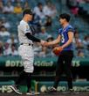ファーストピッチセレモニーに登場したパナソニックインパルス・桑田理介（右）と握手をする阪神・佐藤輝明＝２７日